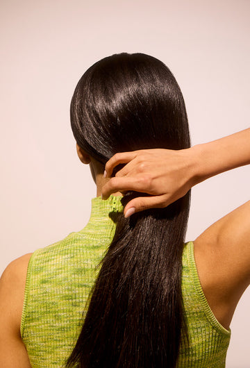 Woman holding her hydrated and smooth hair
